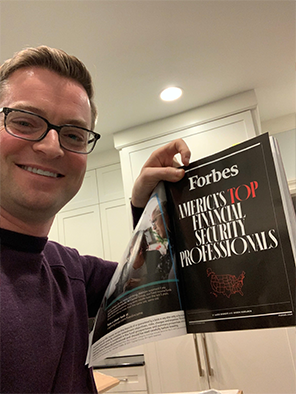 Joel holding the Forbes Magazine